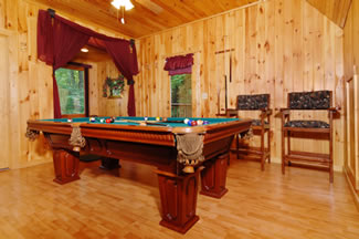 2 billiard seats are featured in the loft game room for the everyone to enjoy a game a pool while relaxing upstairs.
